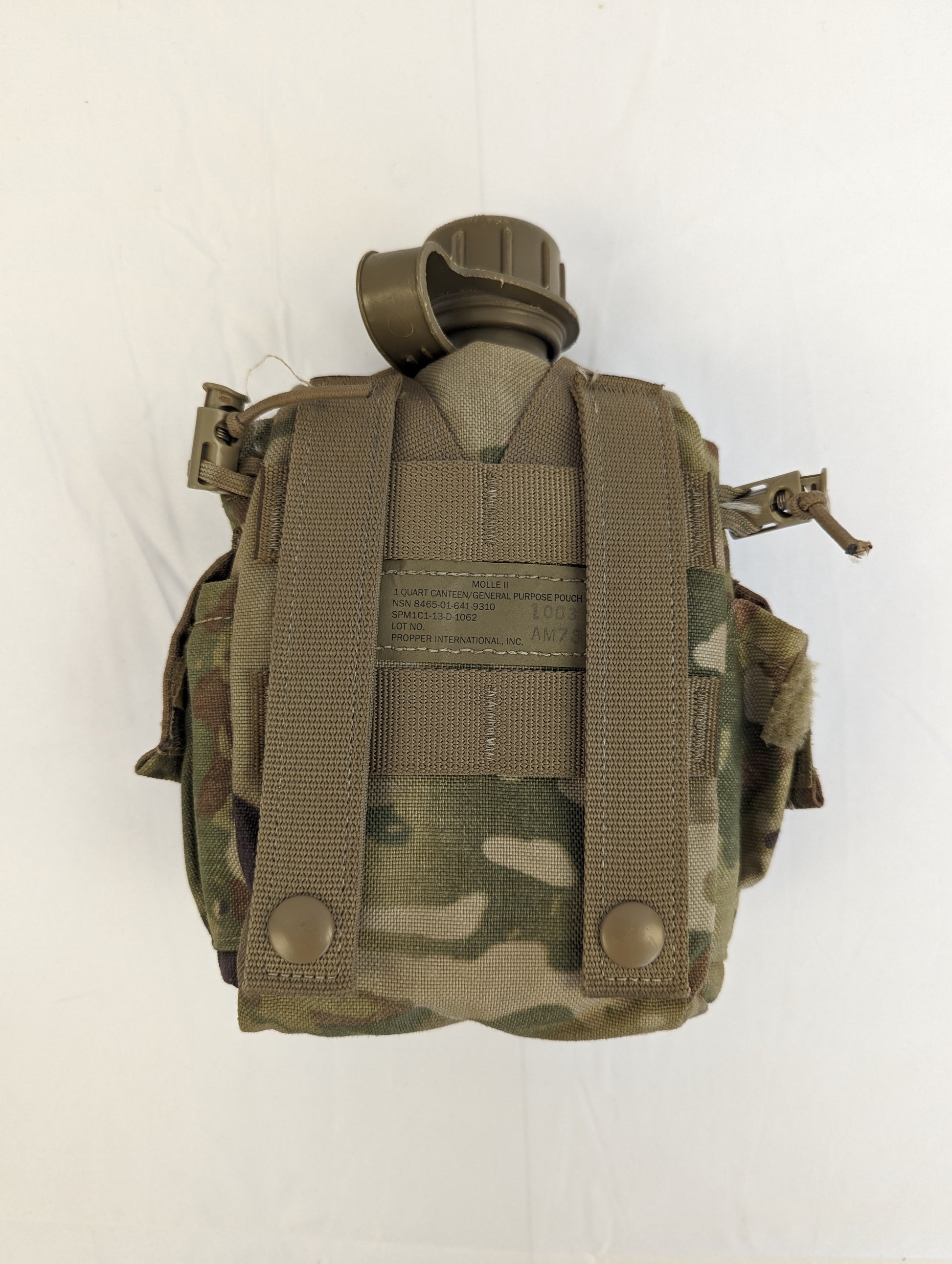 A back view of a U.S. Military 1-quart canteen in olive green, fully contained within a closed OCP/Multicam camouflage pouch, displaying the vertical MOLLE attachment straps.