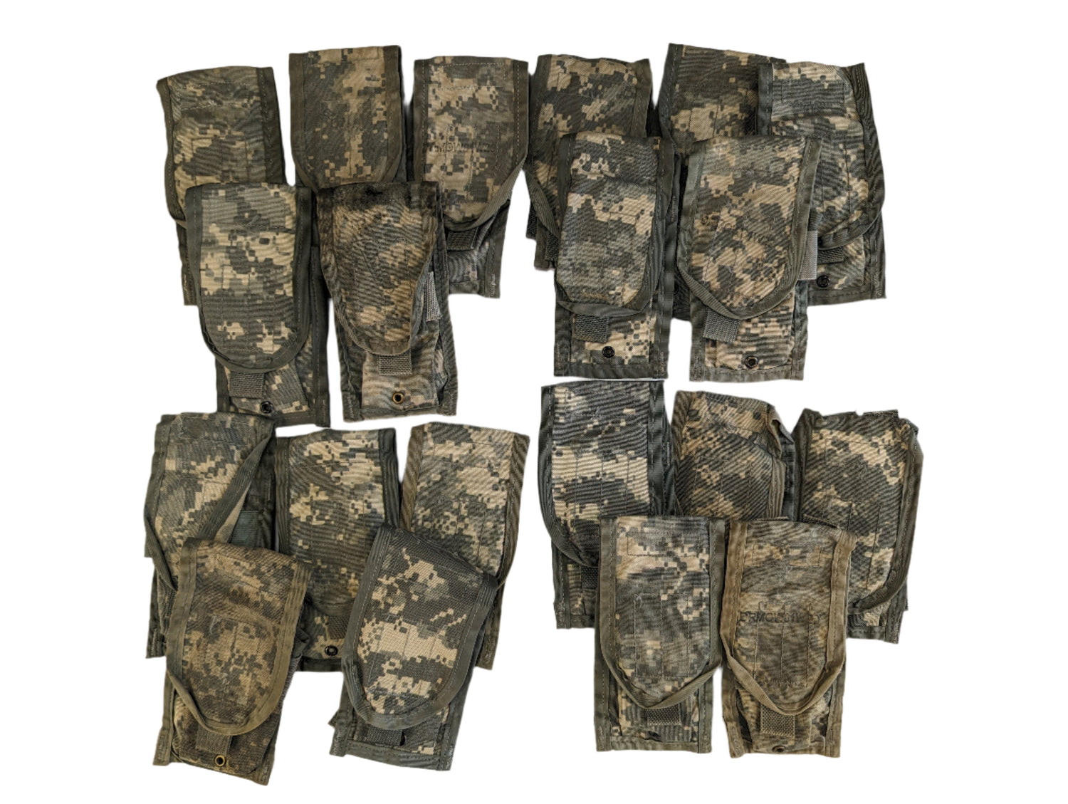 A group of approximately twenty folded U.S. Military Surplus 2-Mag Pouches in ACU digital camouflage, laid out in clusters on a white background.