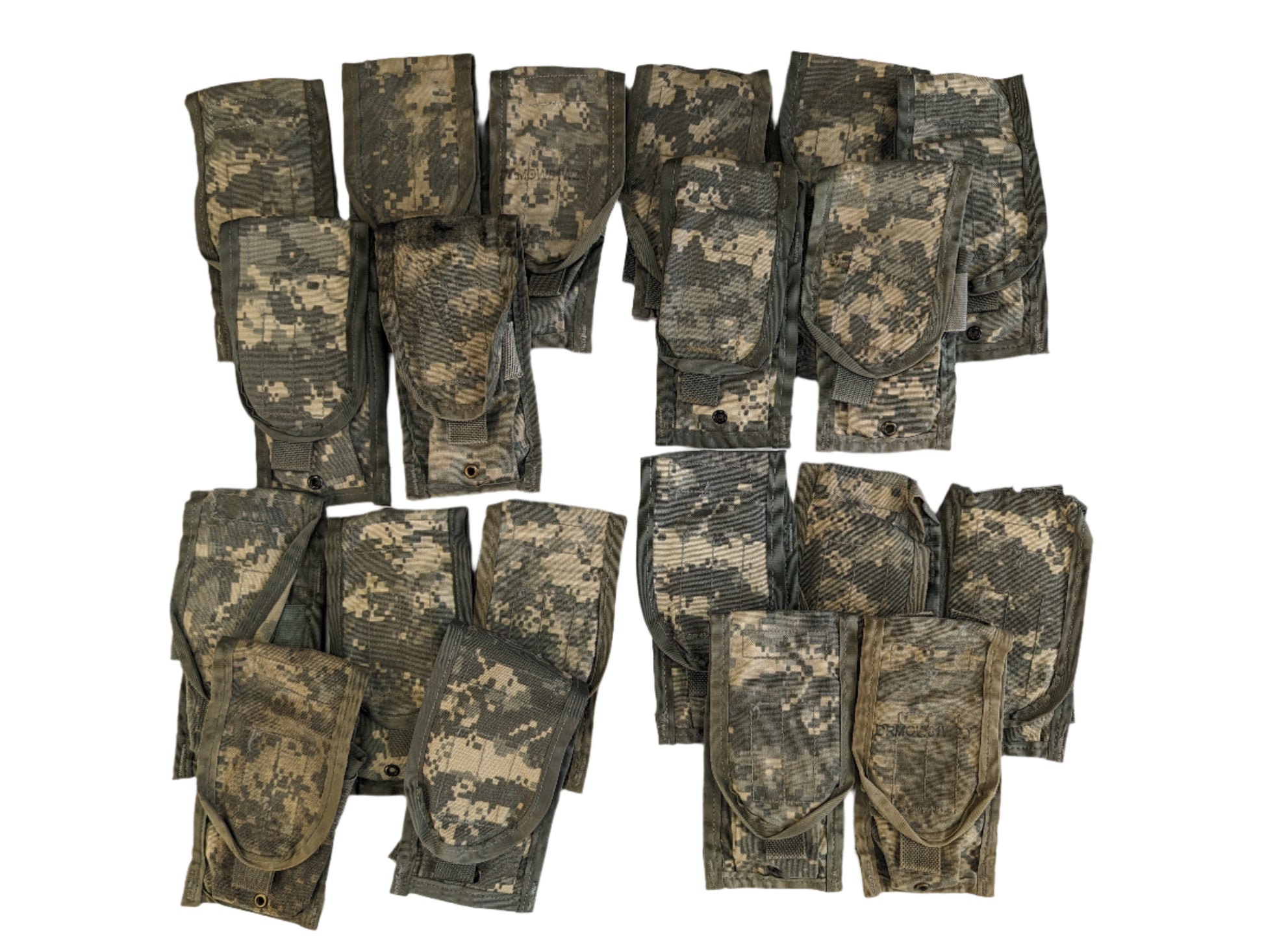 A group of approximately twenty folded U.S. Military Surplus 2-Mag Pouches in ACU digital camouflage, laid out in clusters on a white background.