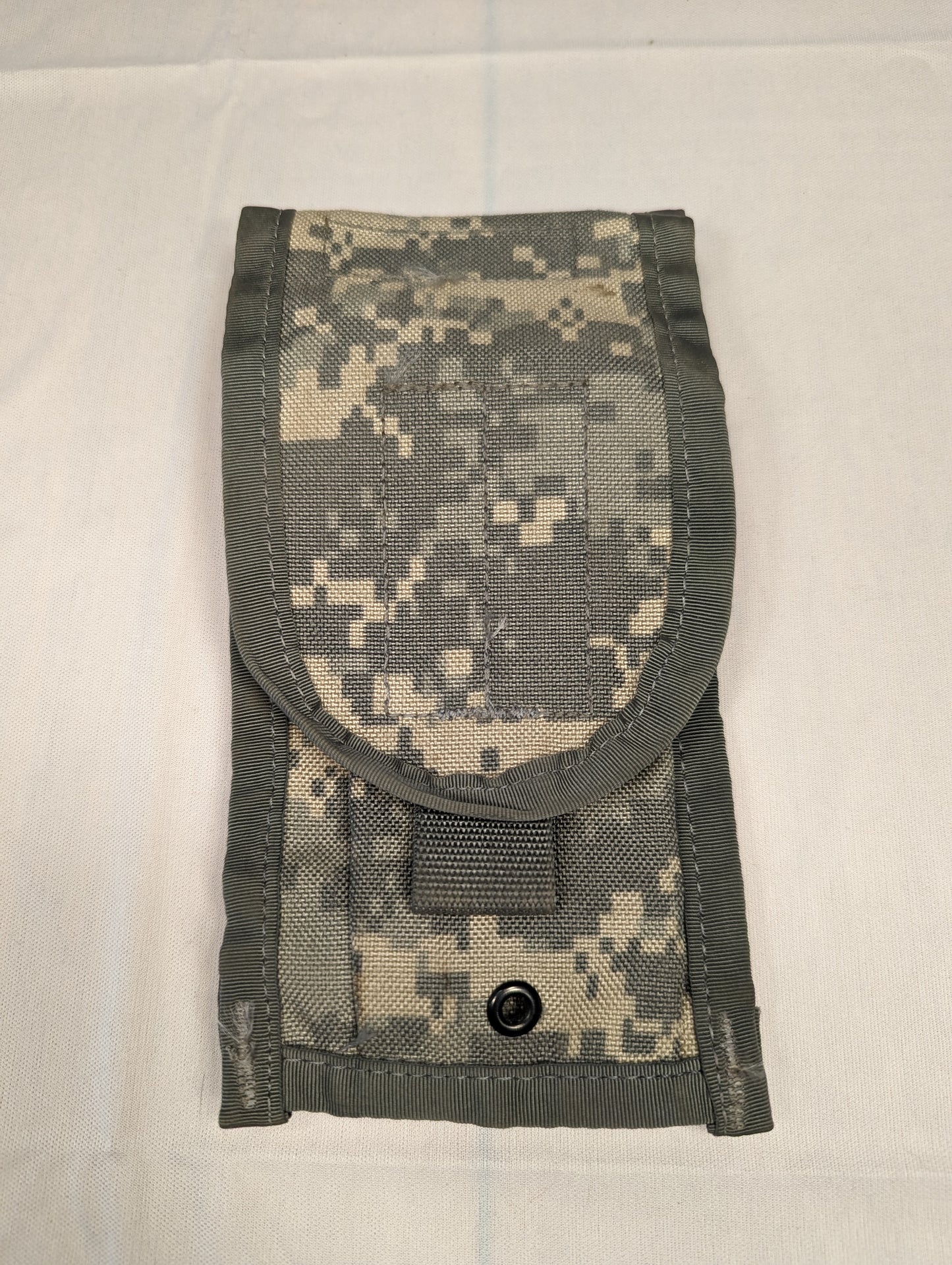 A single U.S. Military Surplus 2-Mag Pouch in ACU/UCP digital camouflage, standing upright and closed, featuring a rounded flap and a black metal snap button closure.