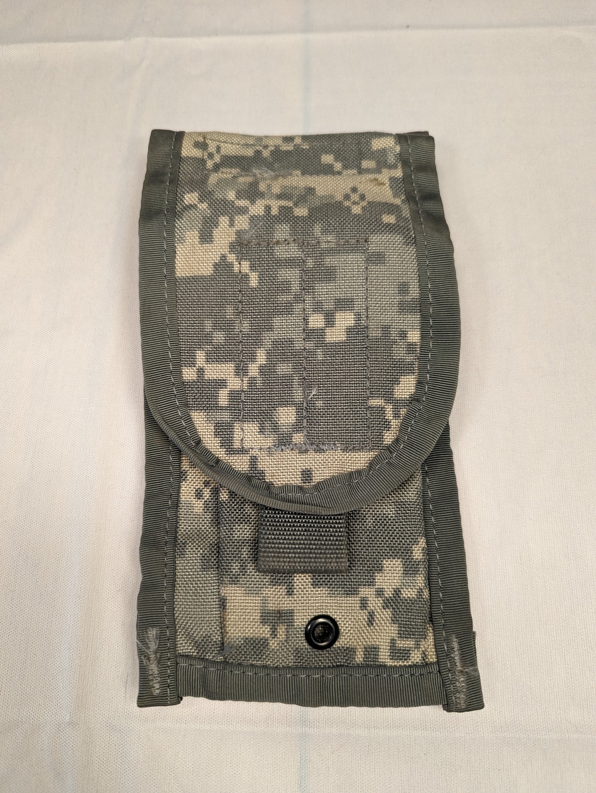 A single U.S. Military Surplus 2-Mag Pouch in ACU/UCP digital camouflage, standing upright and closed, featuring a rounded flap and a black metal snap button closure.