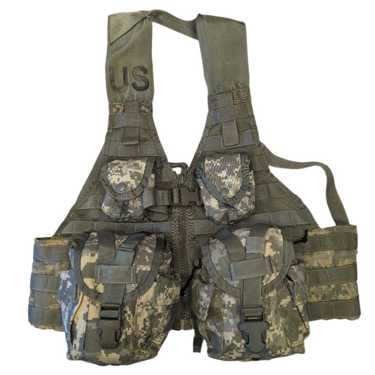 A U.S. Military Surplus Load Carrier Vest (FLC) in ACU digital camouflage, fully assembled with four attached pouches, hanging on a white background, and featuring a prominent stenciled 'US' mark on the chest.
