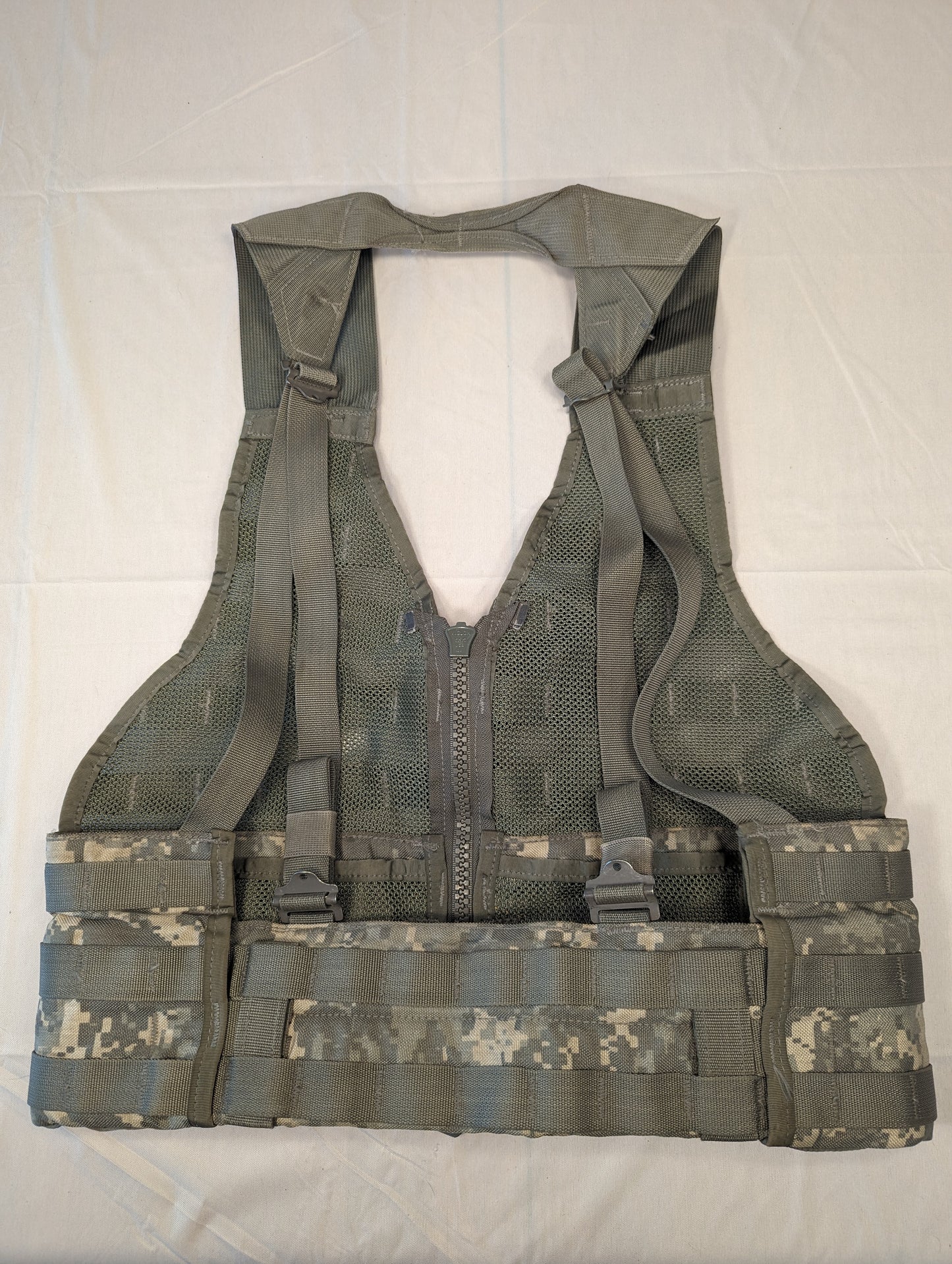 A full front view of a U.S. Military Surplus Load Carrier Vest (FLC) in ACU digital camouflage, unaccessorized, displaying the extensive horizontal MOLLE webbing and padded waist belt.