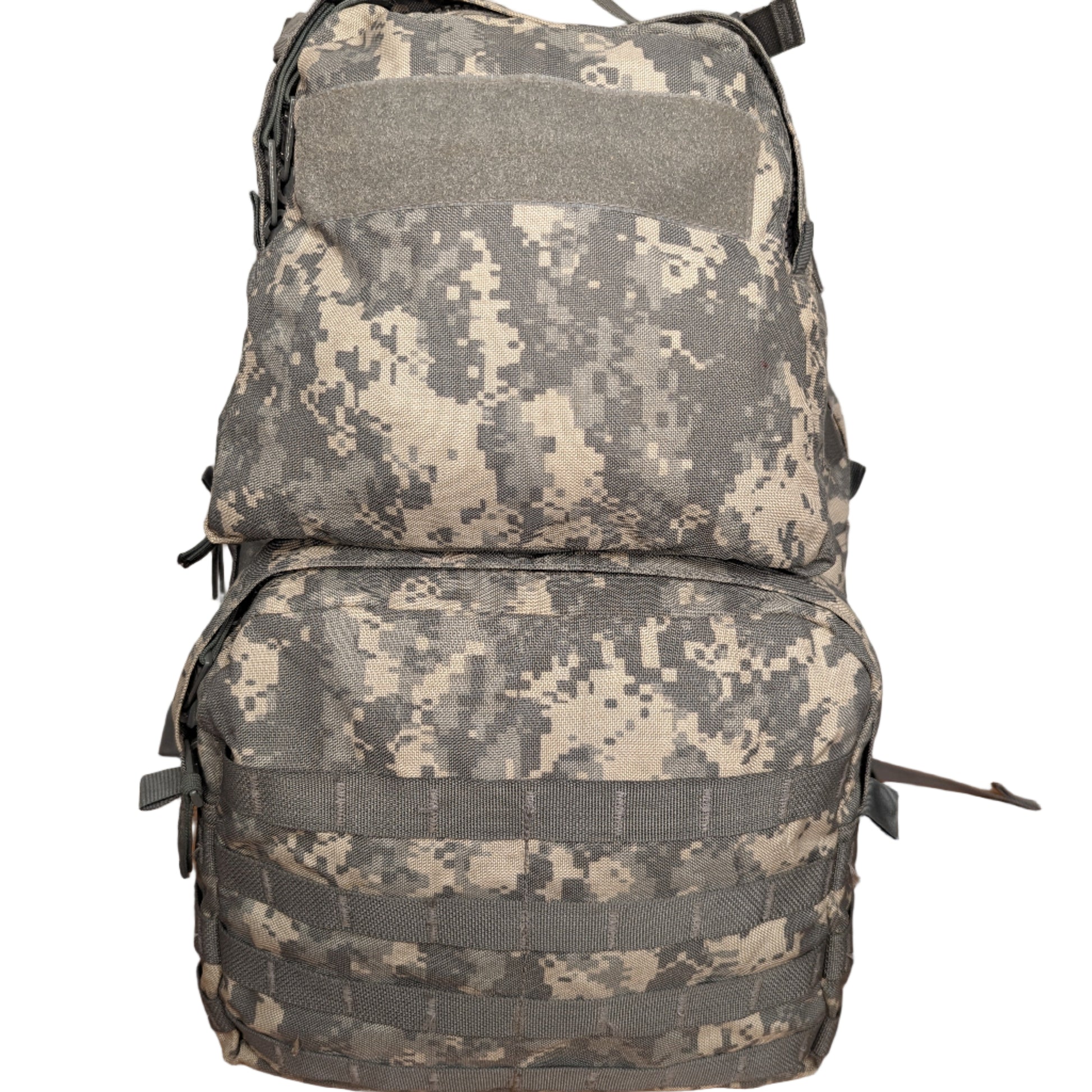 A front view of a U.S. Military Surplus Medium Field Pack in ACU digital camouflage, standing upright, featuring horizontal MOLLE webbing on both the upper and lower compartments and a large hook-and-loop patch field.