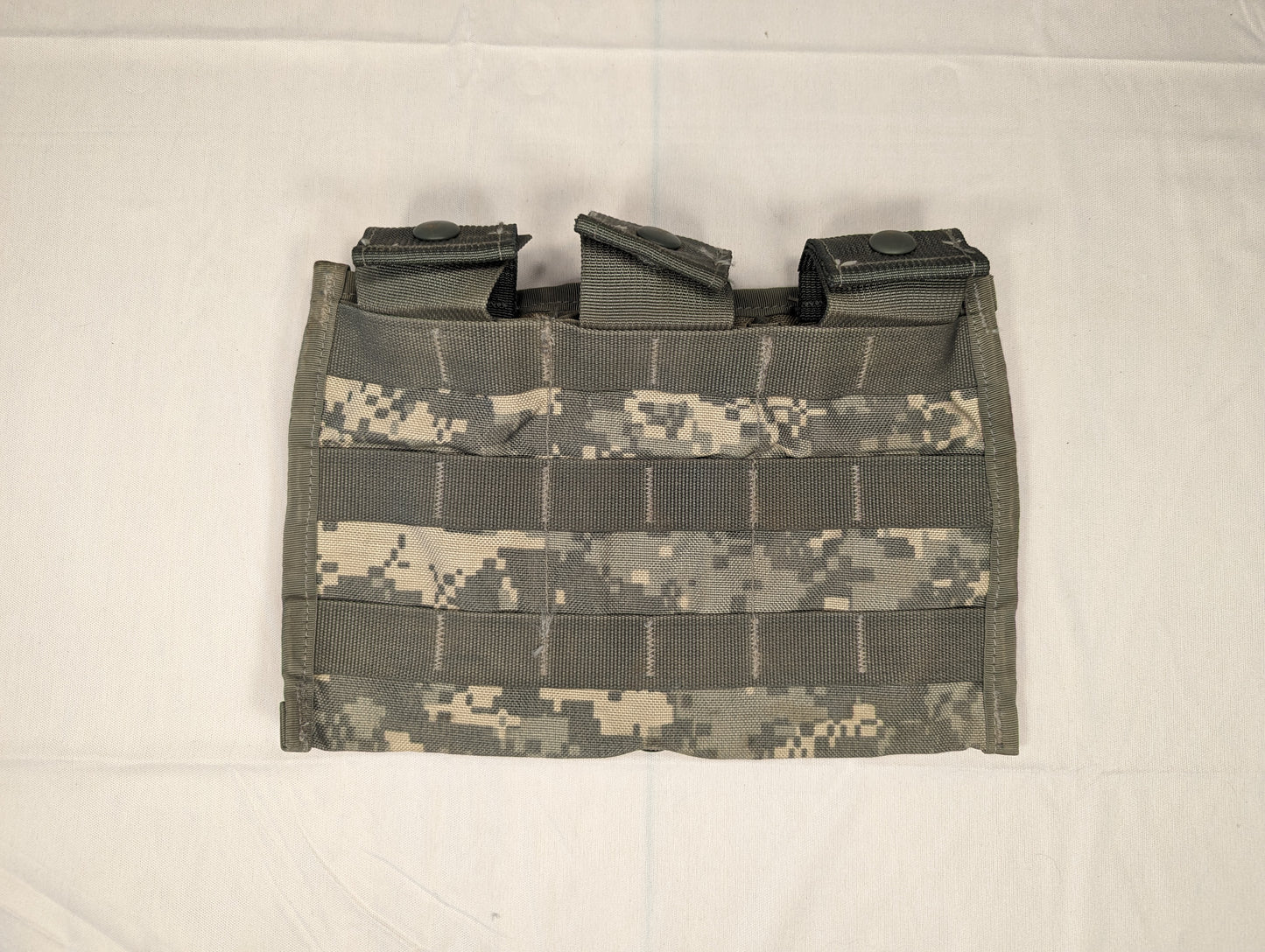 A single U.S. Military Surplus Triple Magazine Pouch in ACU digital camouflage, laid flat, displaying the three vertical magazine slots and dense horizontal MOLLE webbing on the front.
