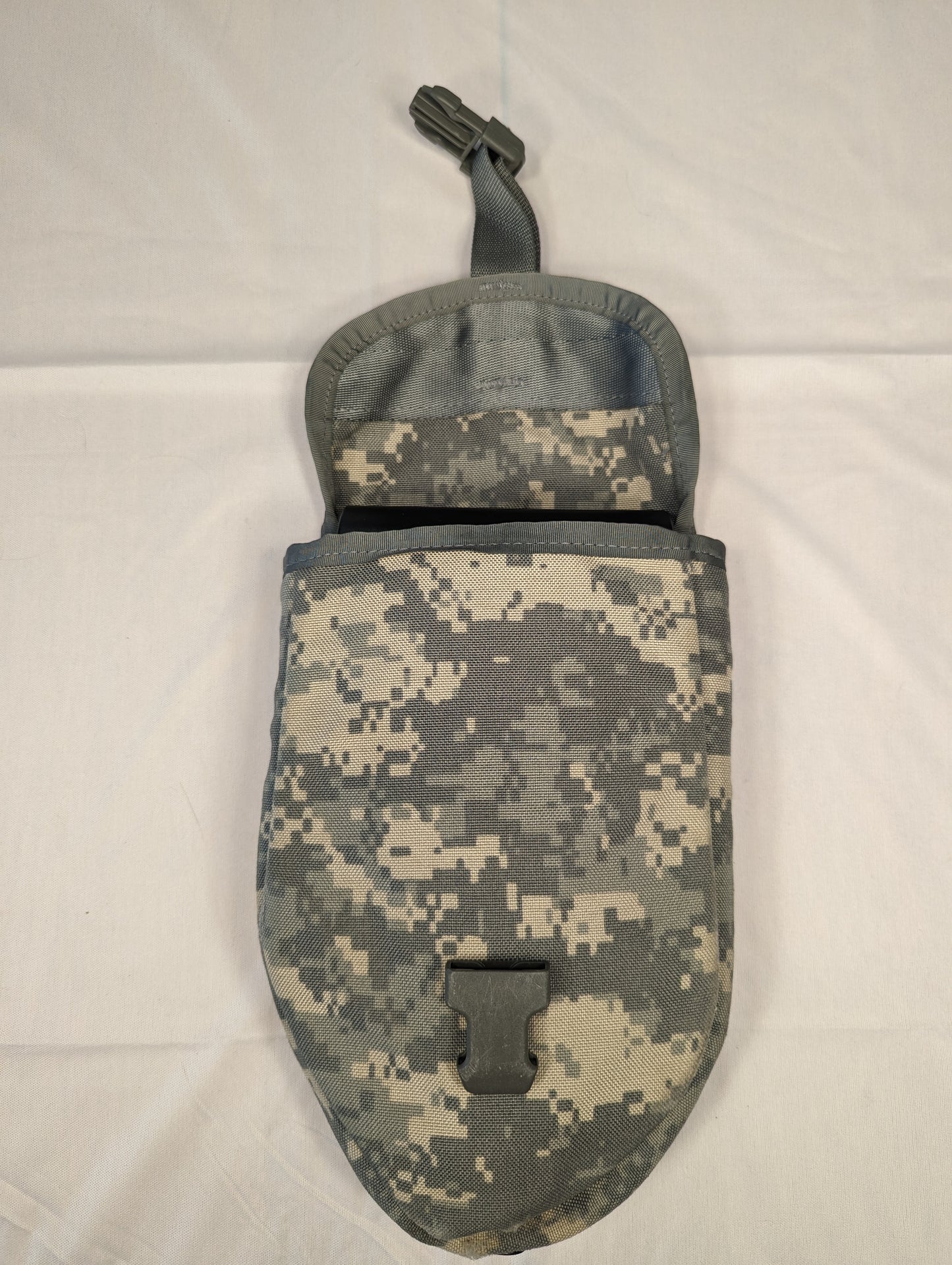 A single U.S. Military Surplus Entrenching Tool Carrier pouch in ACU digital camouflage, standing upright with the top flap open, displaying the black quick-release buckle and the empty interior.