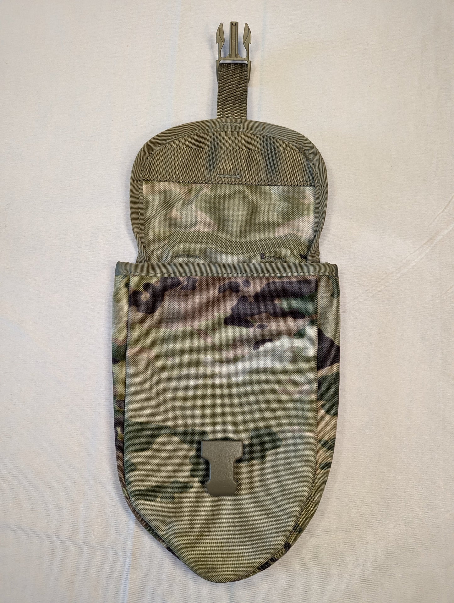 A single U.S. Military Surplus Entrenching Tool Carrier pouch in OCP/Multicam camouflage, standing upright with the top flap open, displaying the tan quick-release buckle and the empty interior.