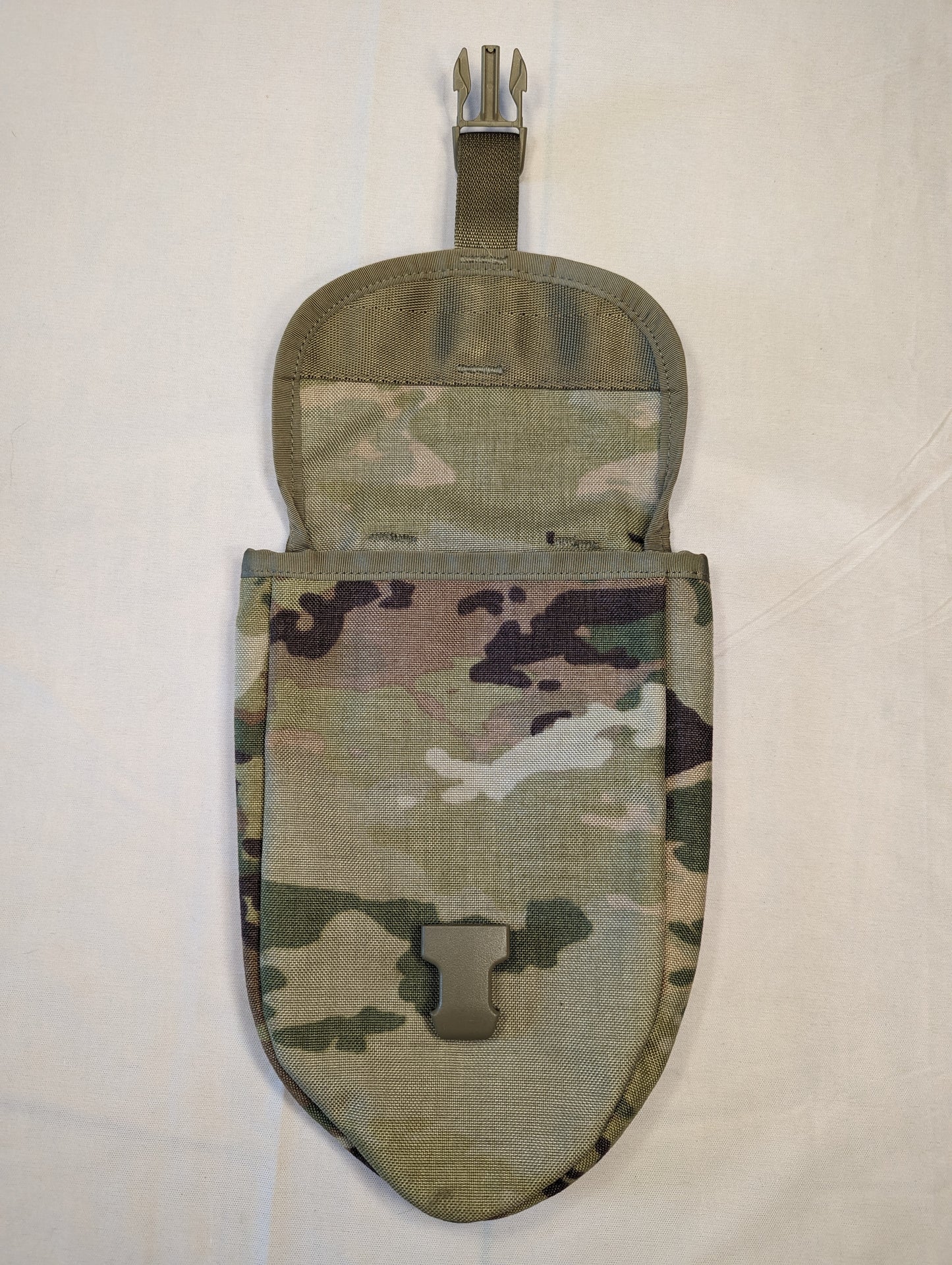 A single U.S. Military Surplus Entrenching Tool Carrier pouch in OCP/Multicam camouflage, standing upright with the top flap open, displaying the metal attachment clip, tan quick-release buckle, and the empty interior.