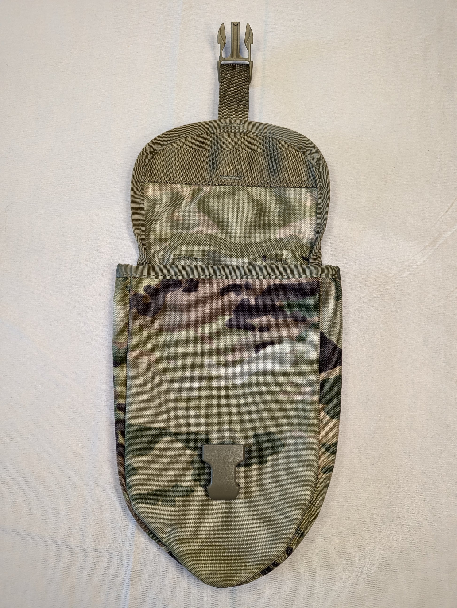 A single U.S. Military Surplus Entrenching Tool Carrier pouch in OCP/Multicam camouflage, standing upright with the top flap open, displaying the metal attachment clip, tan quick-release buckle, and the empty interior.