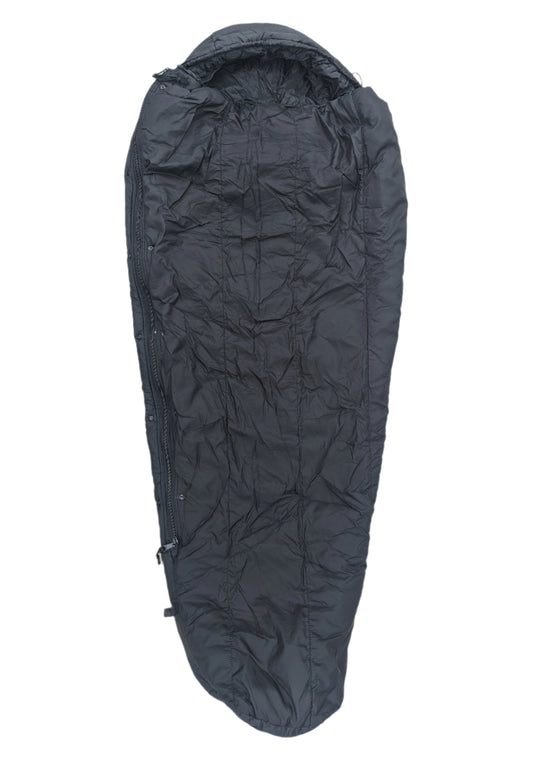 A full-length U.S. Military Surplus Intermediate Cold Weather Sleeping Bag in black, zipped up and isolated on a white background, displaying its mummy shape and quilted, crinkled fabric.