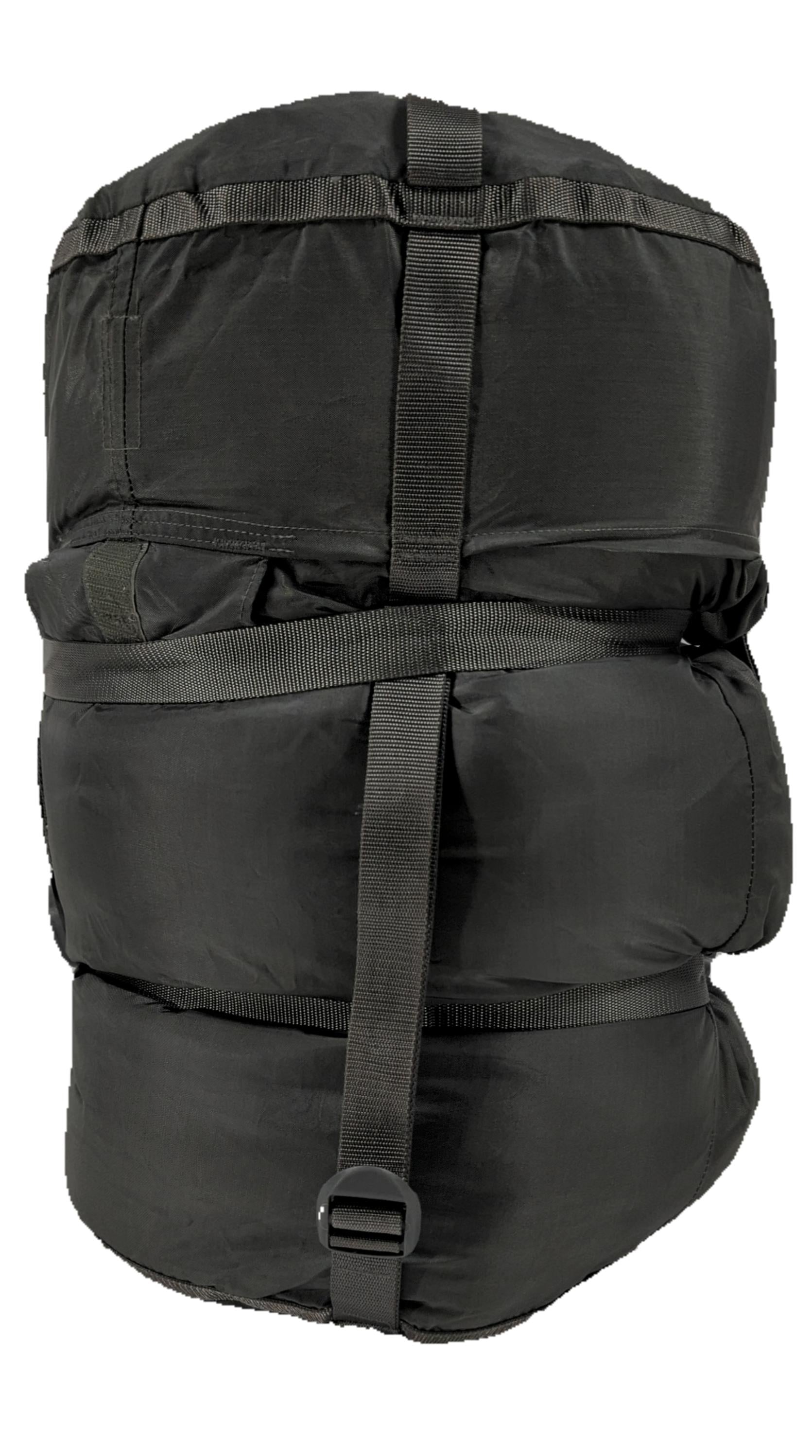 A large black U.S. Military Surplus Modular Sleep System Compression Stuff Sack, fully packed and cinched tight with three rows of horizontal webbing and buckles, displayed on a white background.