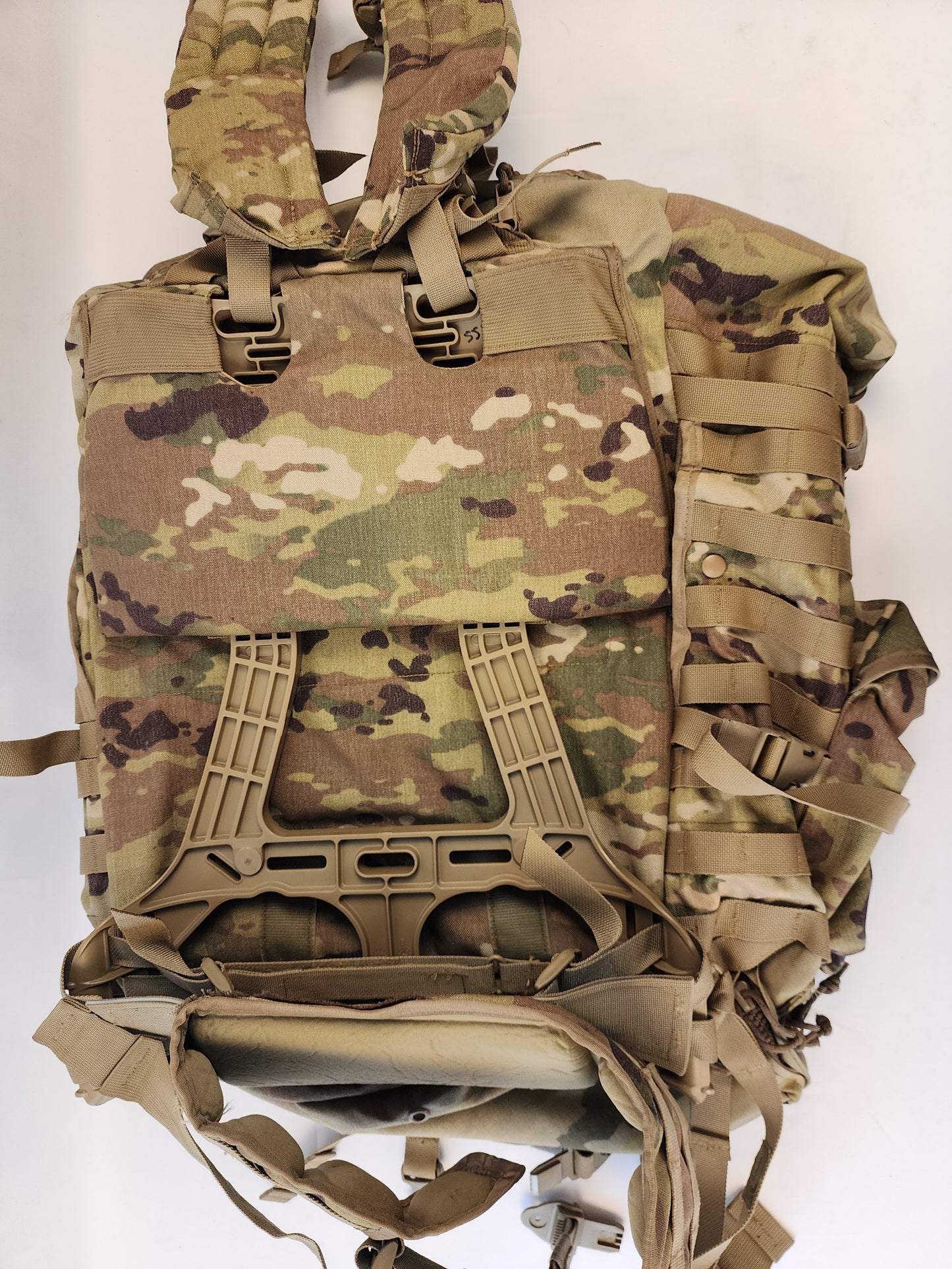 A close-up of the upper front panel of the OCP/Multicam MOLLE 4000 Rucksack, highlighting the heavy-duty quick-release buckles, webbing, and accessory pockets.