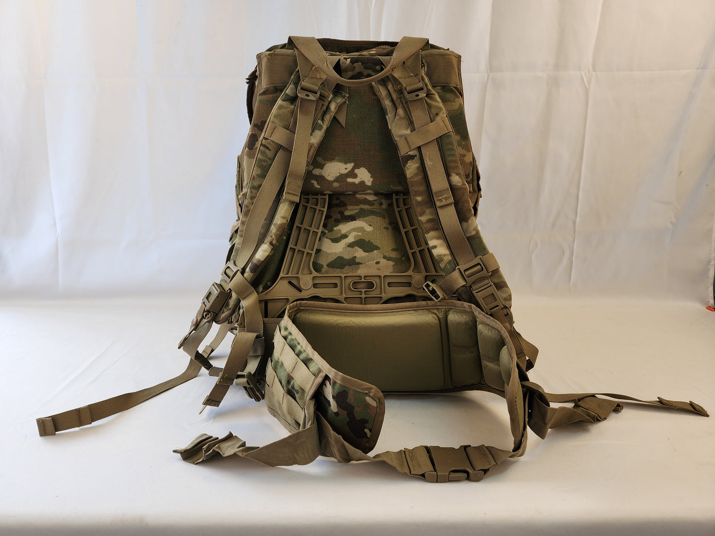 A large U.S. Military Surplus MOLLE 4000 Rucksack in OCP/Multicam camouflage, photographed from the back, displaying the entire shoulder harness, frame, and padded hip belt.