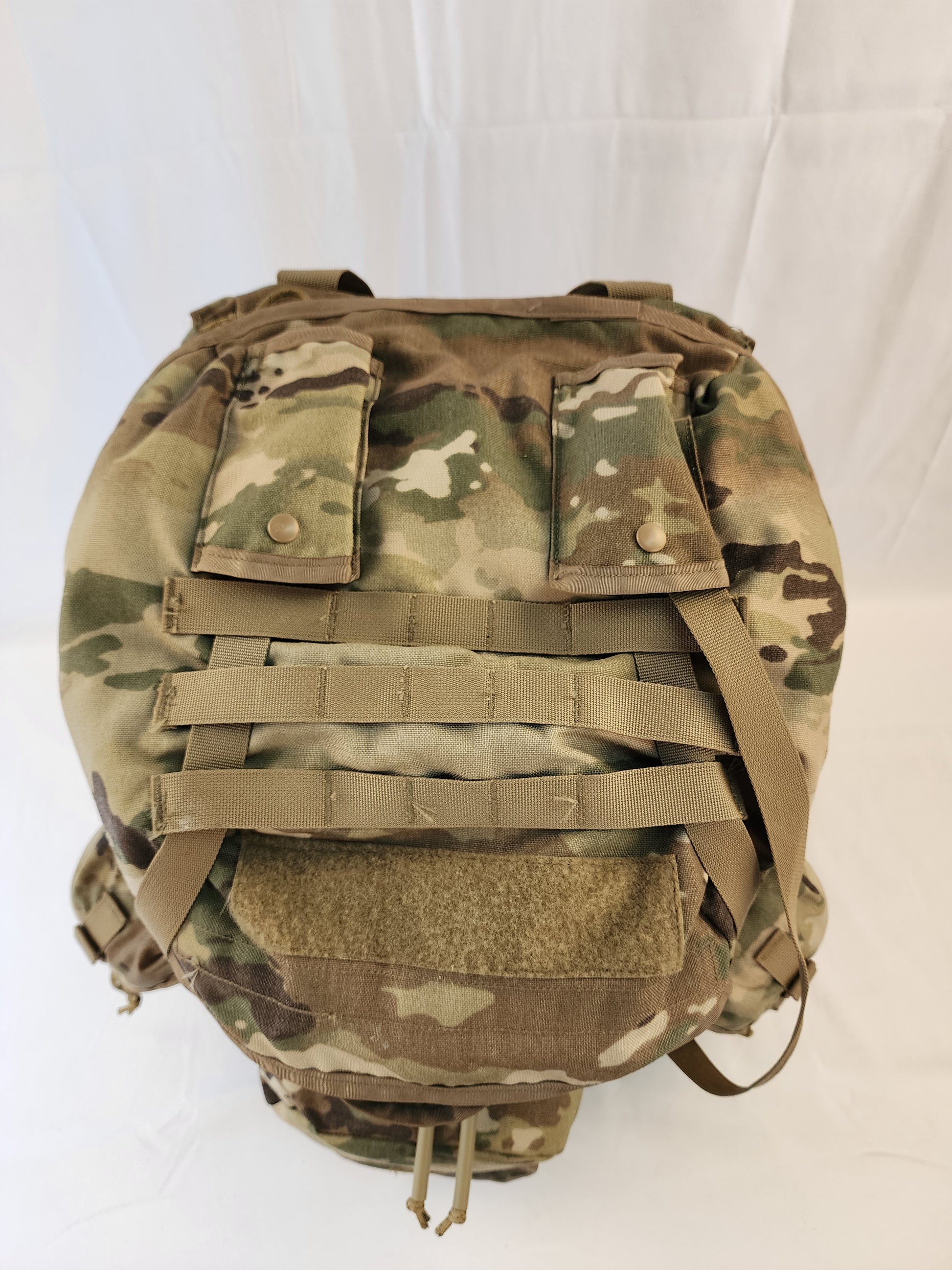 A large U.S. Military Surplus MOLLE 4000 Rucksack in OCP/Multicam camouflage, shown from the top on a white background, highlighting the compression straps and horizontal webbing.