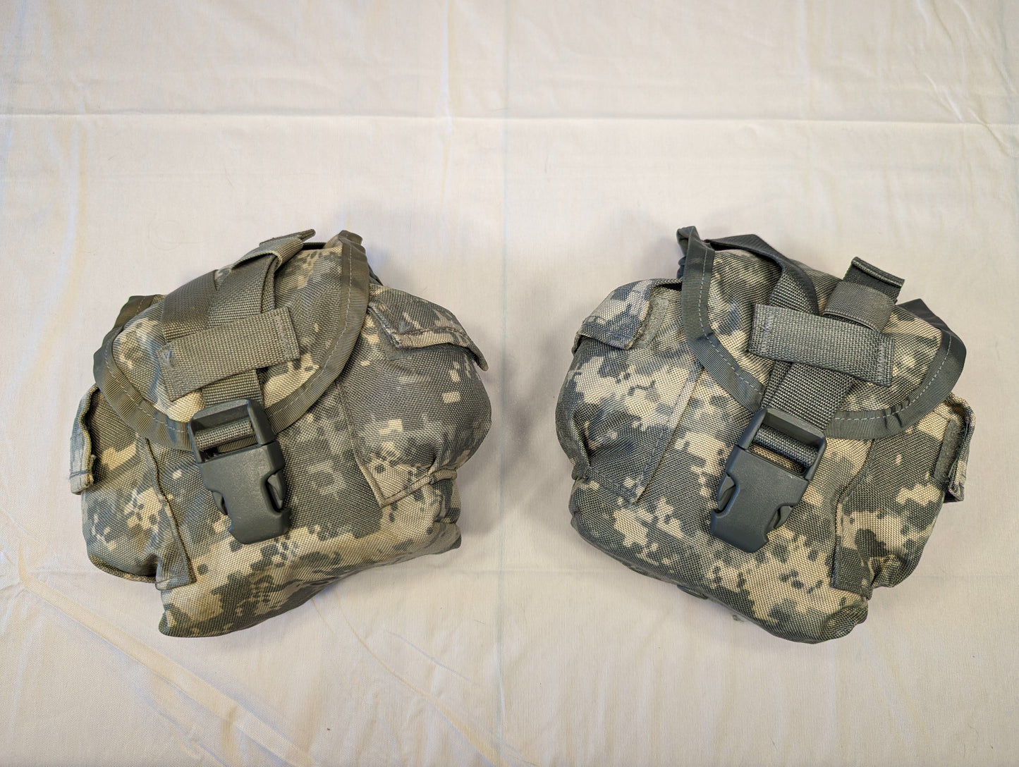 Two U.S. Military Surplus MOLLE II 1-Quart Canteen/General Purpose Pouches in ACU digital camouflage, laid side-by-side on a white background, featuring flap closures secured by large black quick-release buckles.