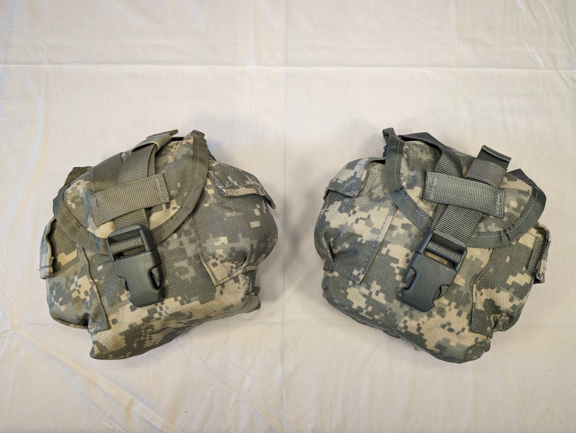Two U.S. Military Surplus MOLLE II 1-Quart Canteen/General Purpose Pouches in ACU digital camouflage, laid side-by-side on a white background, featuring flap closures secured by large black quick-release buckles.