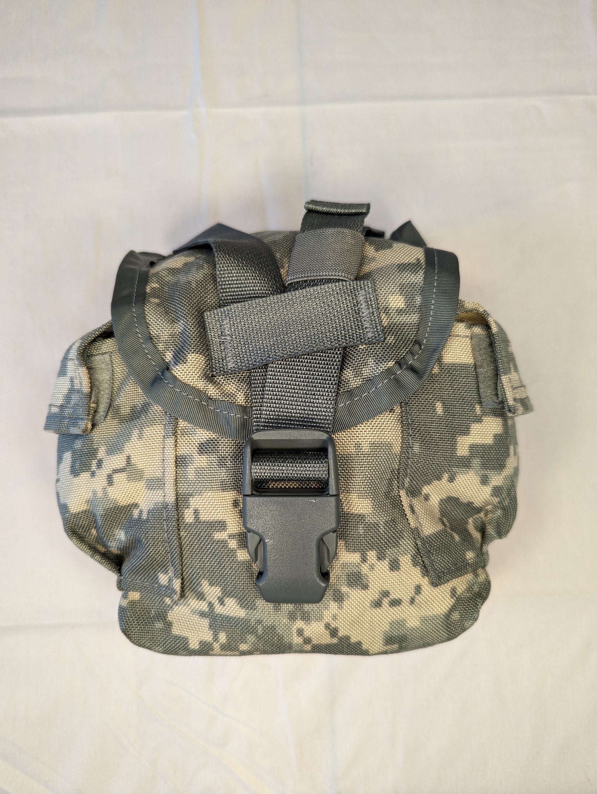 A single U.S. Military Surplus MOLLE II 1-Quart Canteen/General Purpose Pouch in ACU digital camouflage, standing upright on a white background, featuring a flap closure secured by a black plastic quick-release buckle.