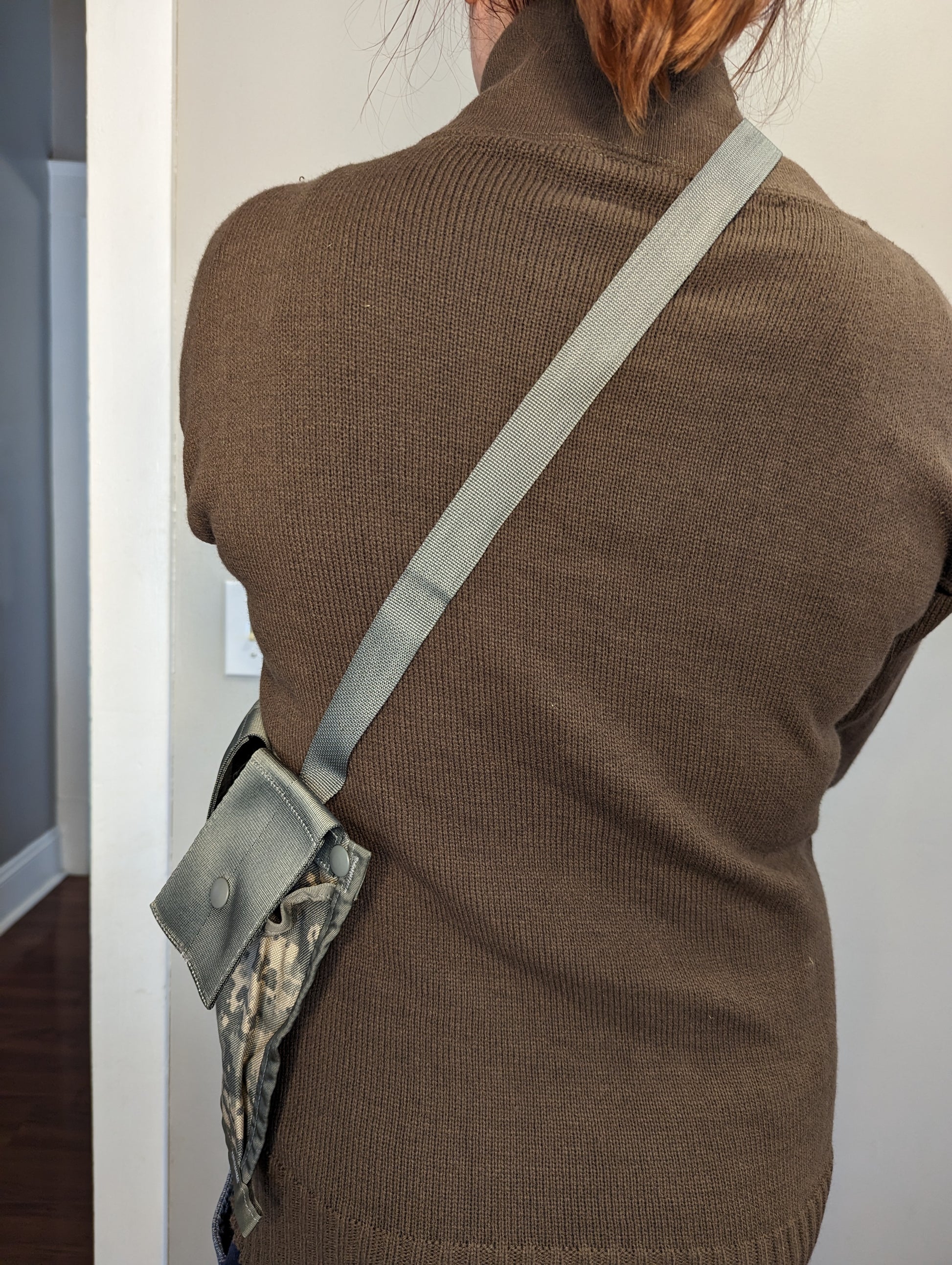 A rear view of a person wearing a U.S. Military Surplus MOLLE II Bandoleer in ACU digital camouflage, demonstrating the shoulder strap fit and pouch positioning across the back.