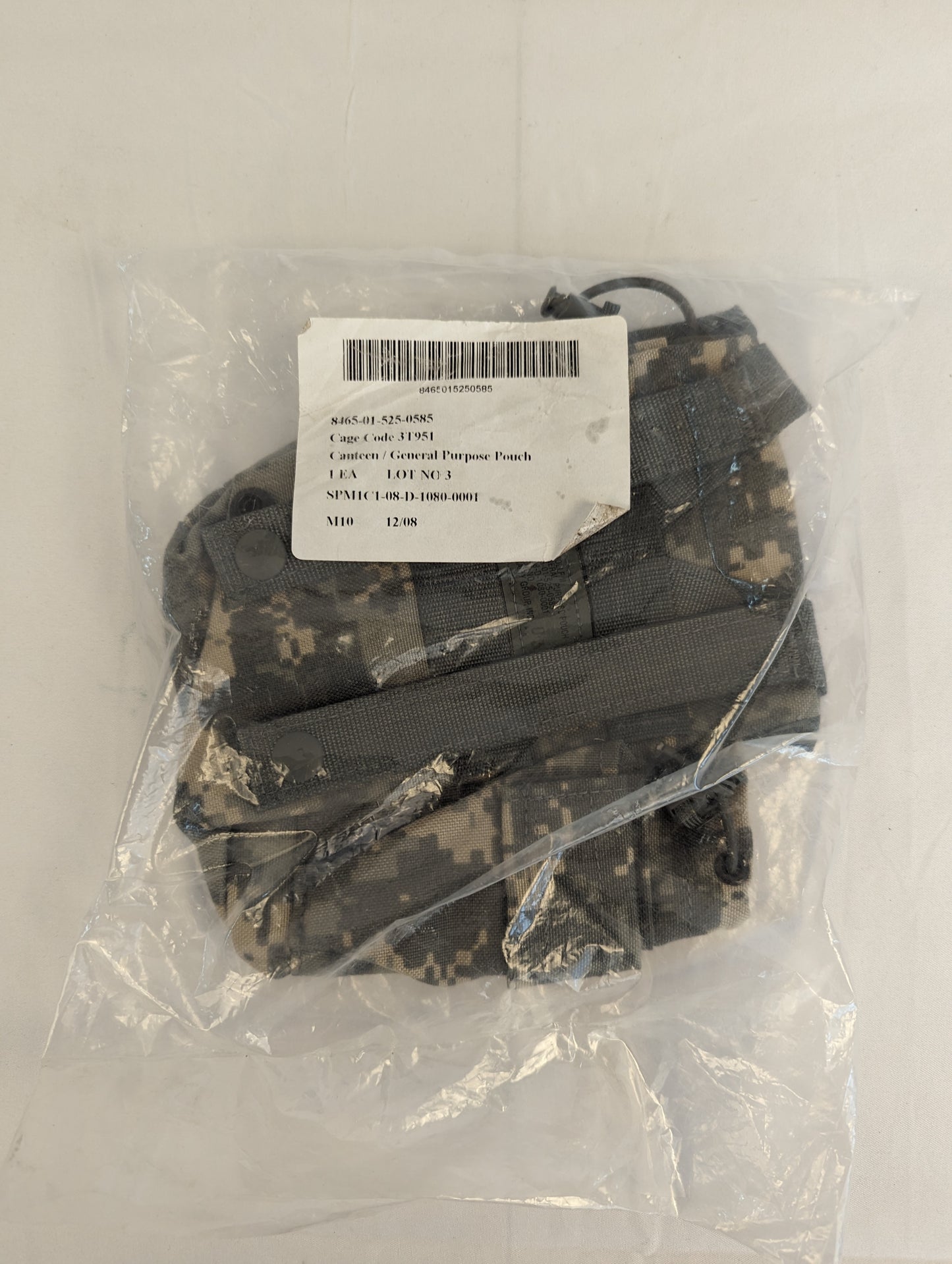 A new U.S. Military Surplus Canteen/General Purpose Pouch in ACU digital camouflage, sealed inside clear plastic packaging, featuring a white issue label with the product name and military identifying numbers.