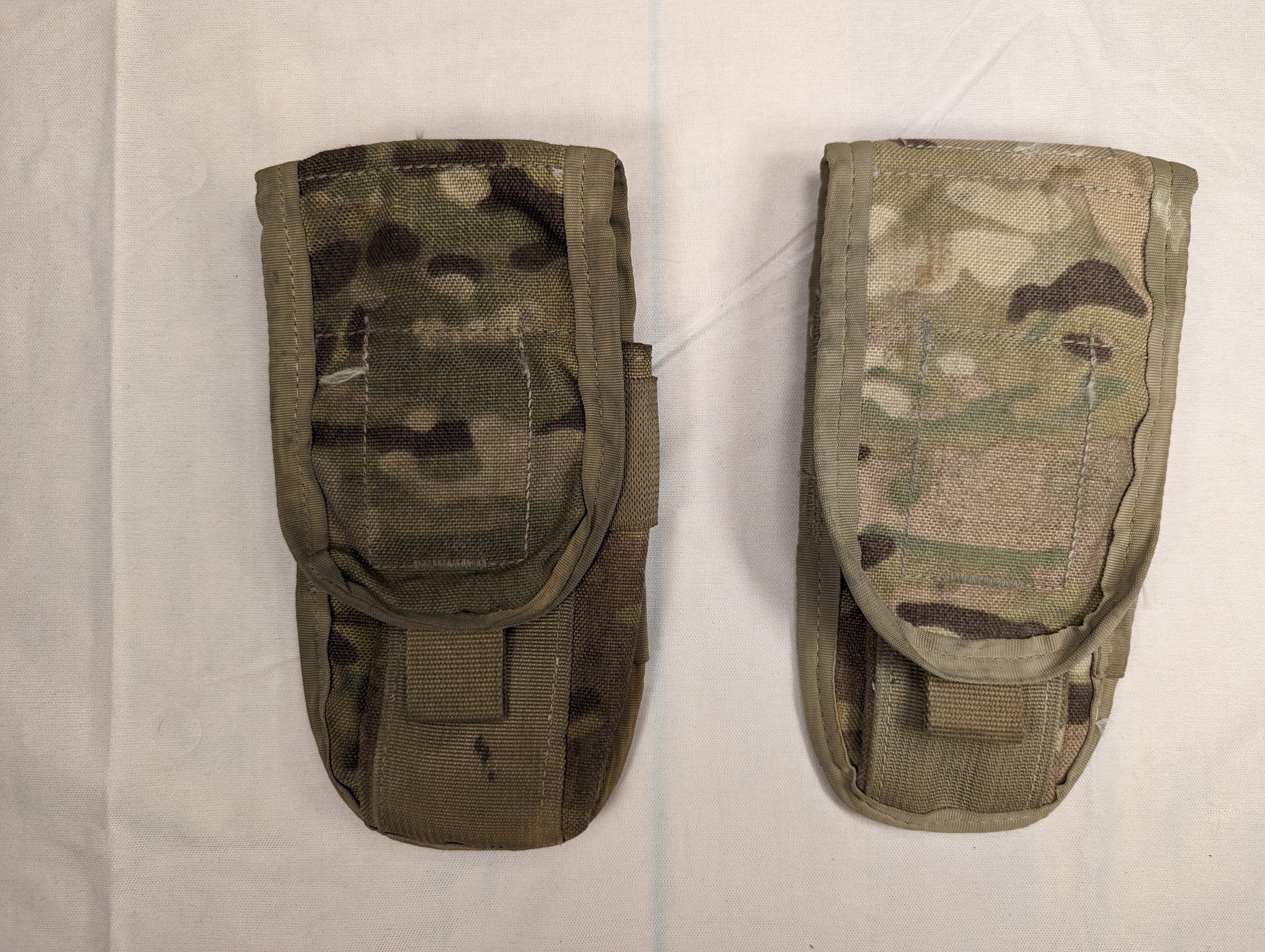 Two U.S. Military Surplus MOLLE II Double Magazine Pouches in OCP/Multicam camouflage, laid side-by-side on a white background, featuring hook-and-loop flap closures and pull tabs.