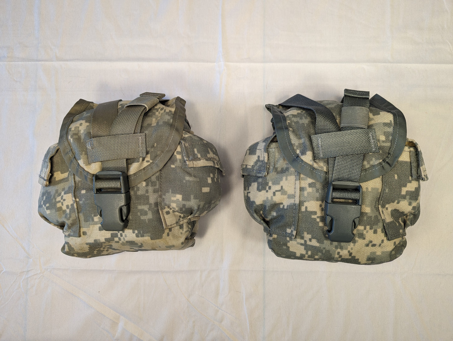 A pair of U.S. Military Surplus MOLLE II General Purpose Pouches in ACU digital camouflage, laid side-by-side, featuring a top flap secured by a plastic quick-release buckle and vertical webbing strap.