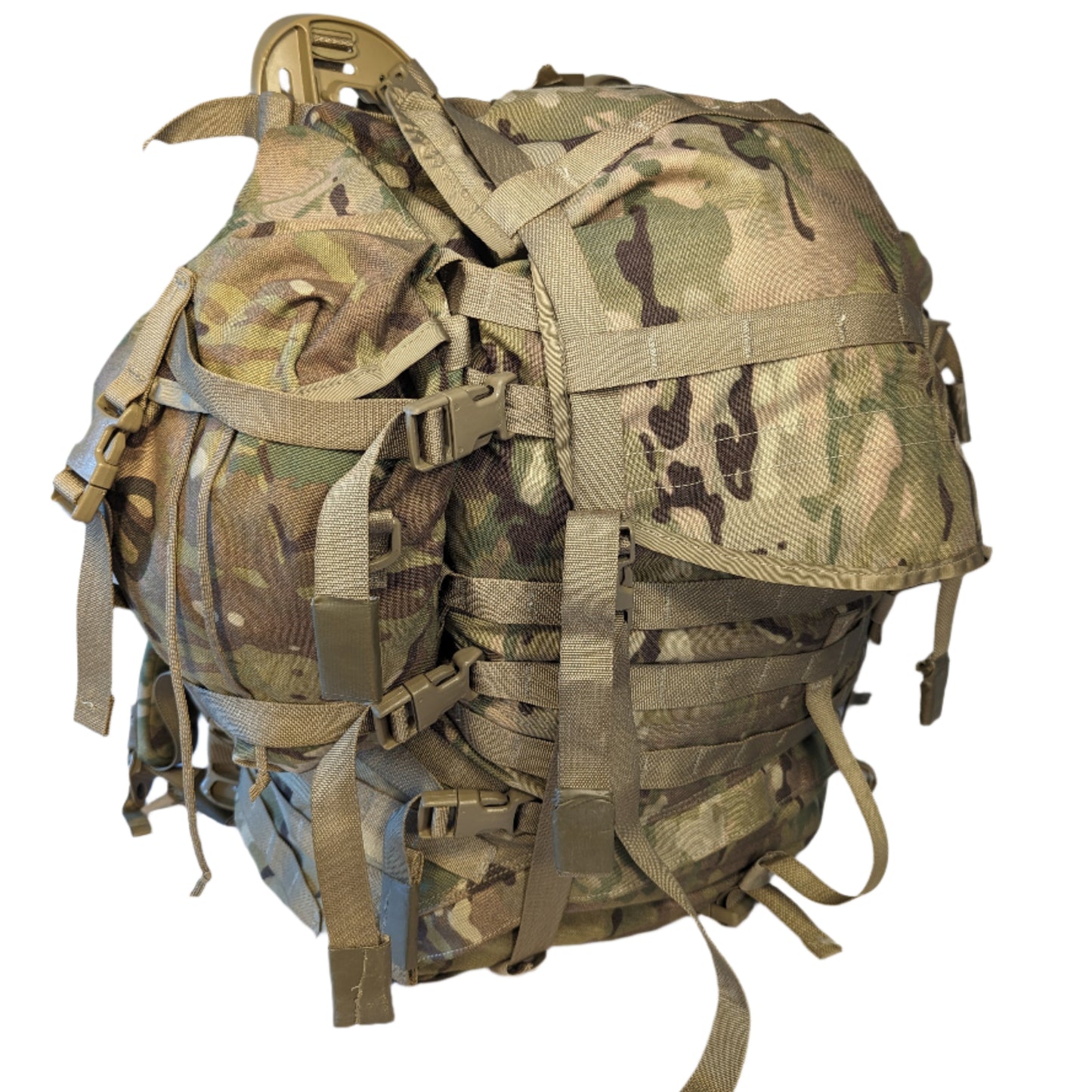 A large U.S. Military Surplus Large Field Pack in OCP/Multicam camouflage, heavily compressed and standing upright, featuring numerous horizontal MOLLE webbing rows and vertical compression straps.