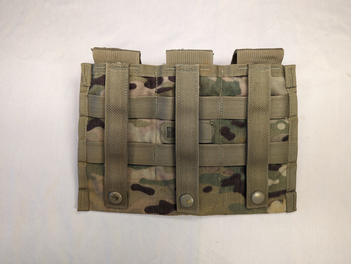 A single U.S. Military Surplus MOLLE II Triple Magazine Pouch in OCP/Multicam camouflage, laid flat, featuring three side-by-side cells with snap-button flap closures and dense horizontal MOLLE webbing.