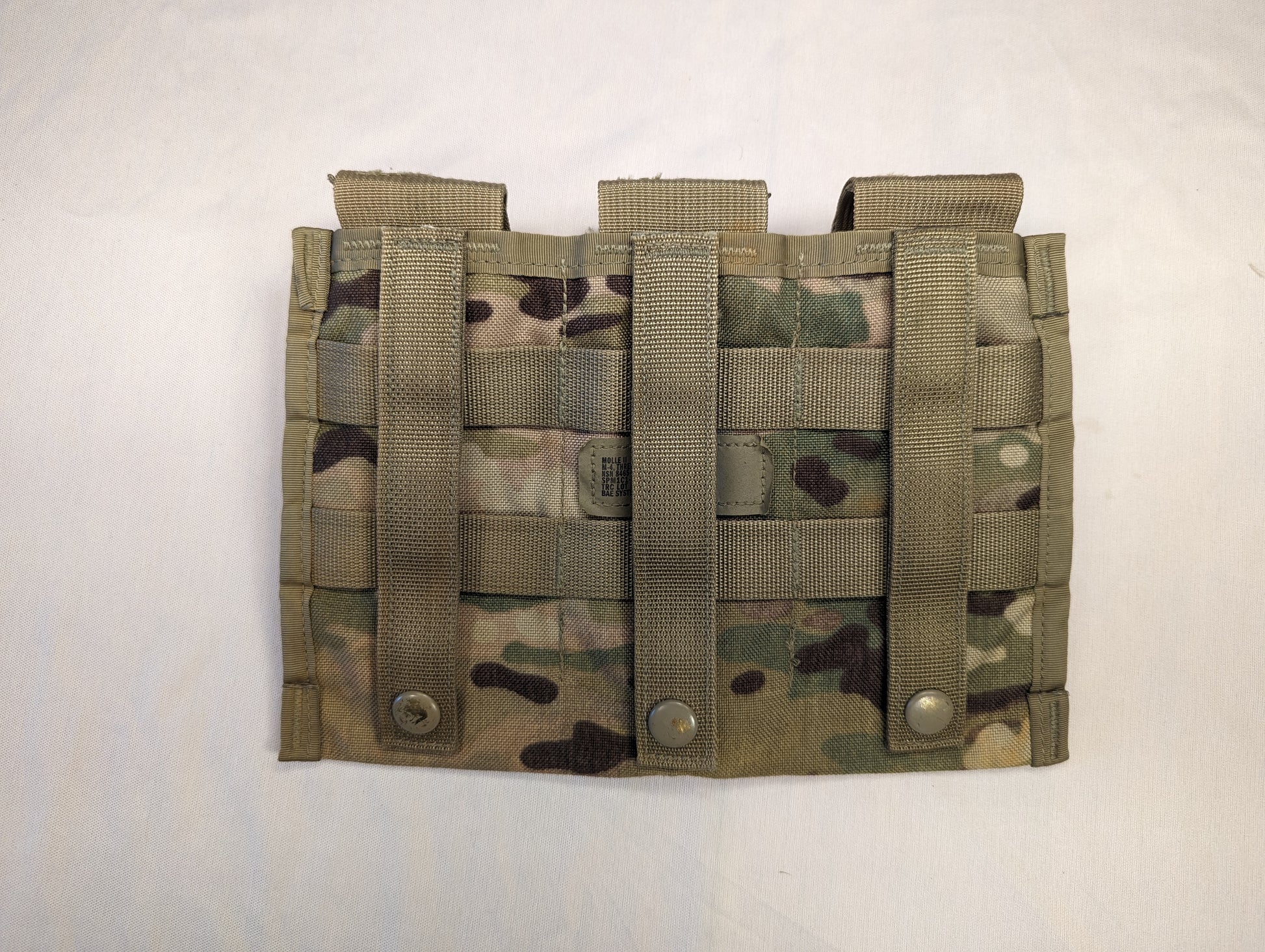 A single U.S. Military Surplus MOLLE II Triple Magazine Pouch in OCP/Multicam camouflage, laid flat, featuring three side-by-side cells with snap-button flap closures and dense horizontal MOLLE webbing.