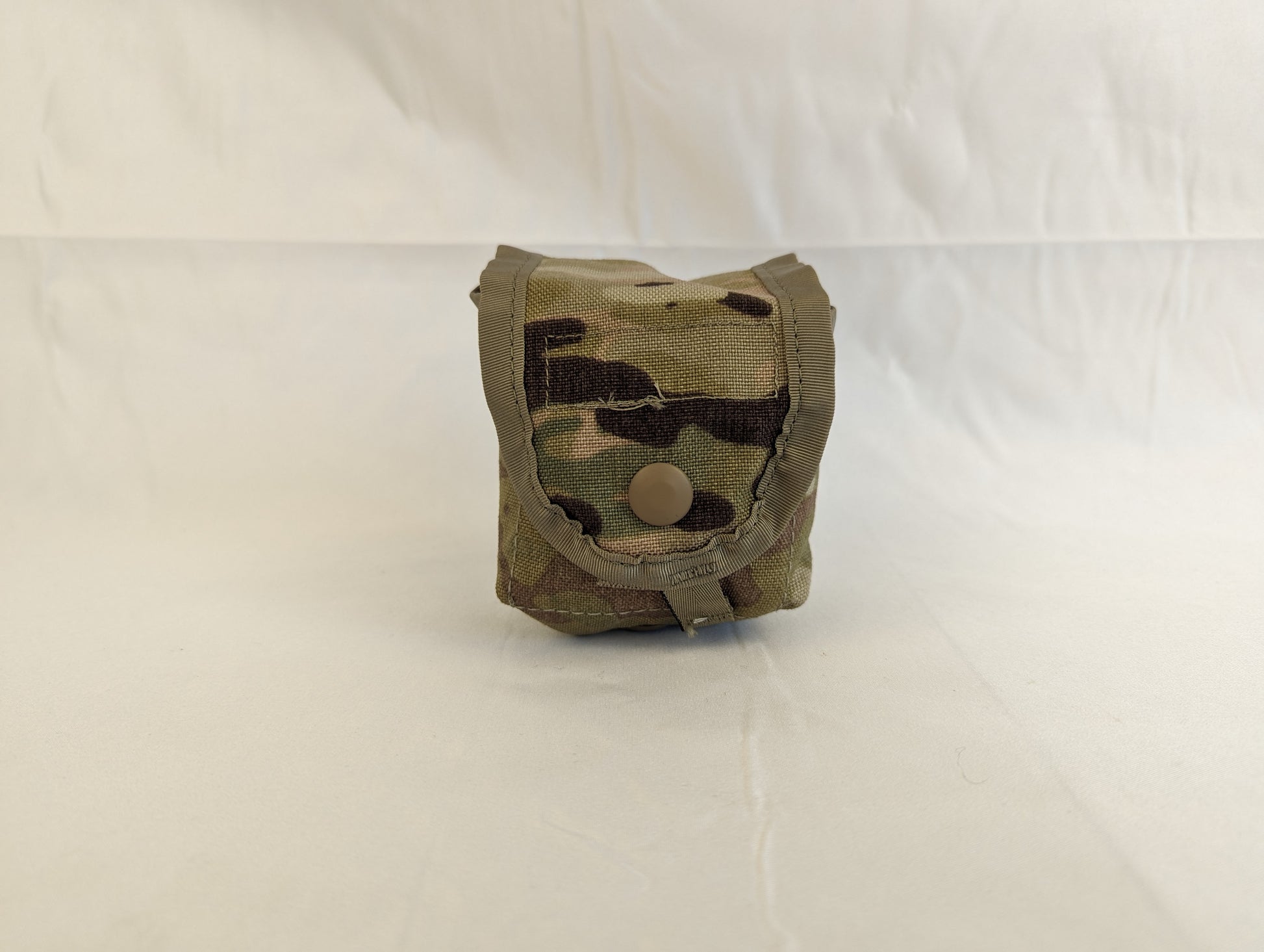 A single U.S. Military Surplus hand grenade pouch in OCP/Multicam camouflage, standing upright on a white background, highlighting the square, box-like shape and snap-button closure.
