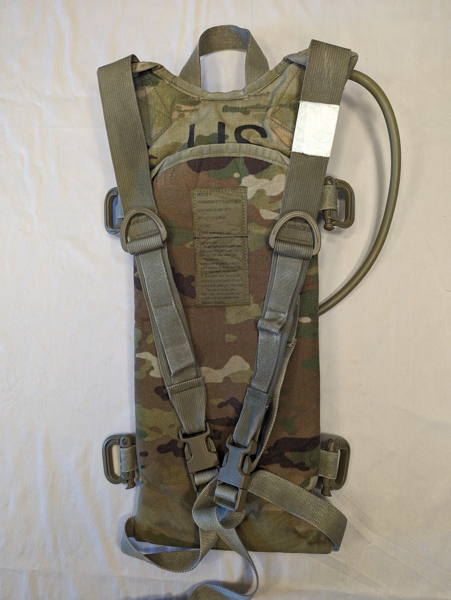 Camouflage hydration pack with straps on a white background