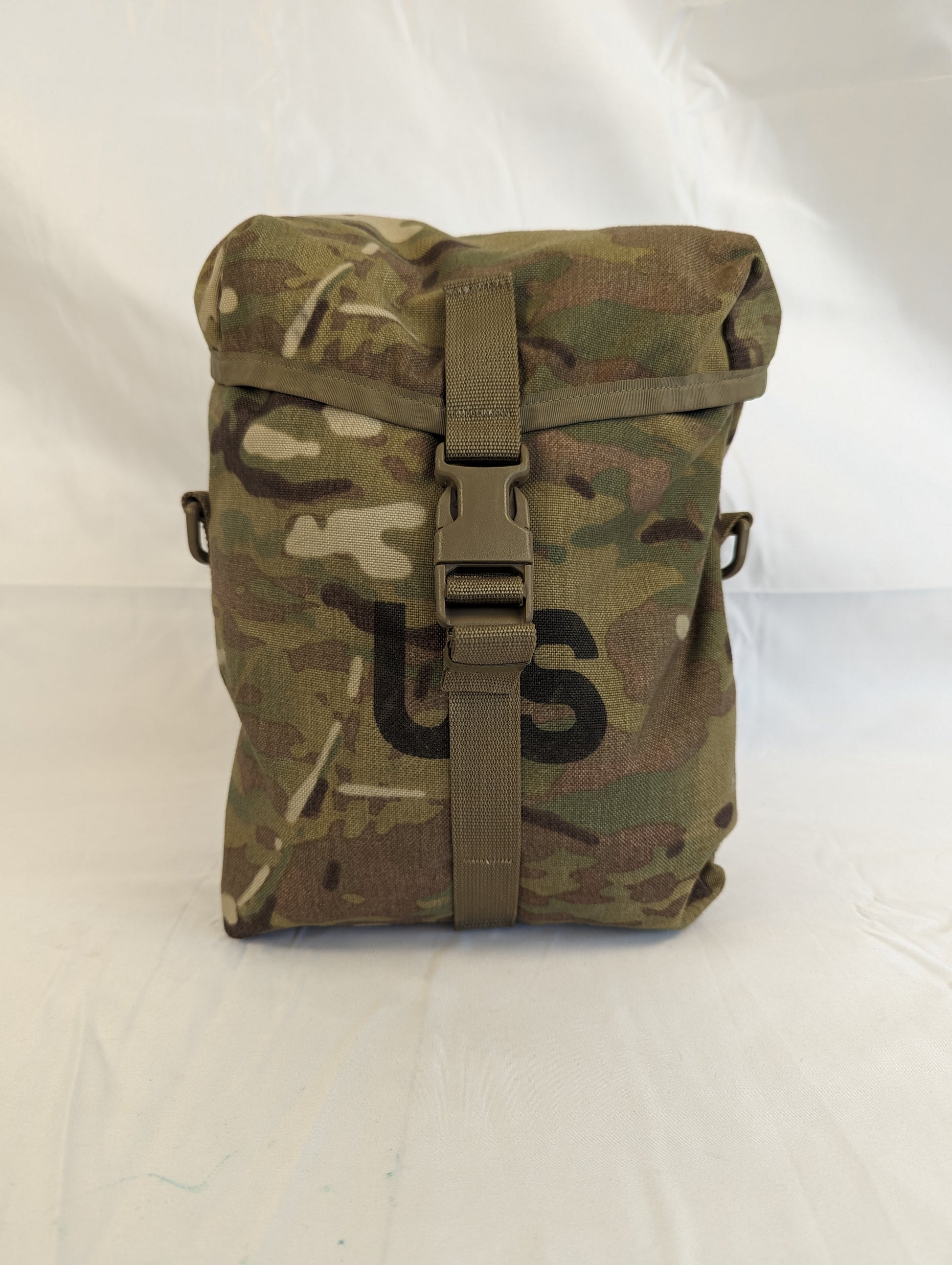 A front view of a U.S. Military Surplus Sustainment Pouch in OCP/Multicam camouflage, standing upright, featuring a buckle-secured top flap, MOLLE webbing, and the large stenciled 'US' mark.