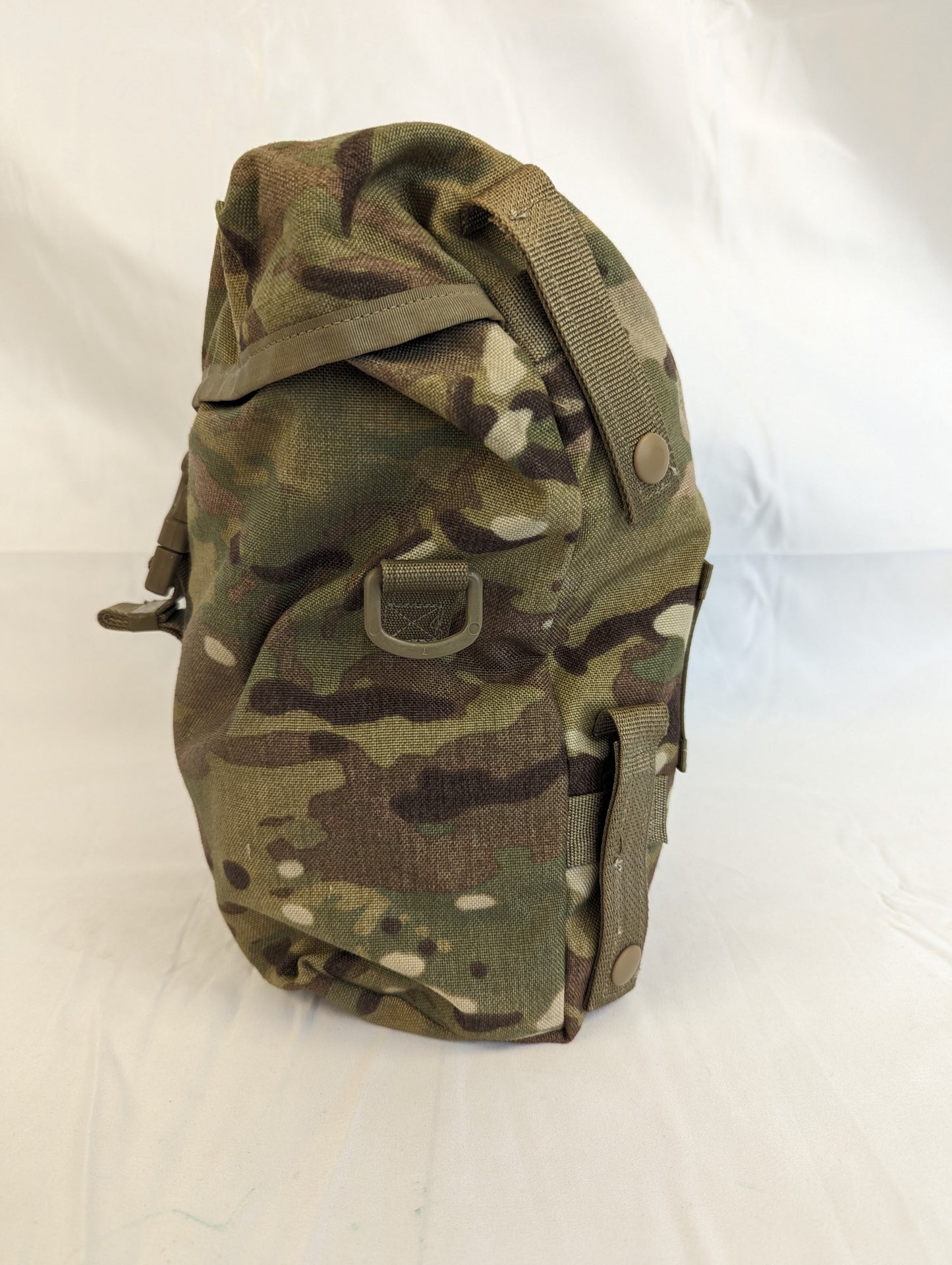 A side view of a U.S. Military Surplus Sustainment Pouch in OCP/Multicam camouflage, stuffed full to capacity and resting on a white background, highlighting its bulk and profile.
