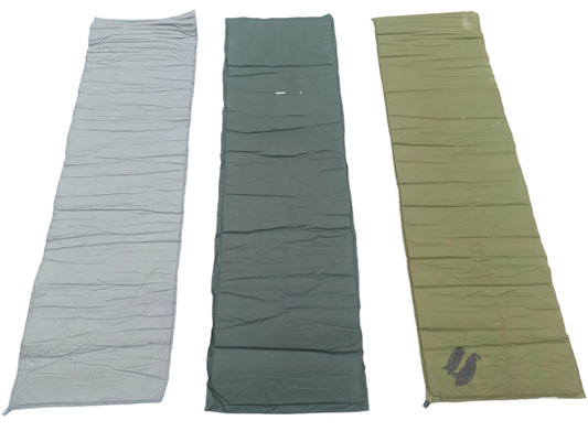 Three U.S. Military surplus self-inflating sleeping mats laid flat side-by-side on a white background, showing color variations in foliage green, dark gray, and olive drab.