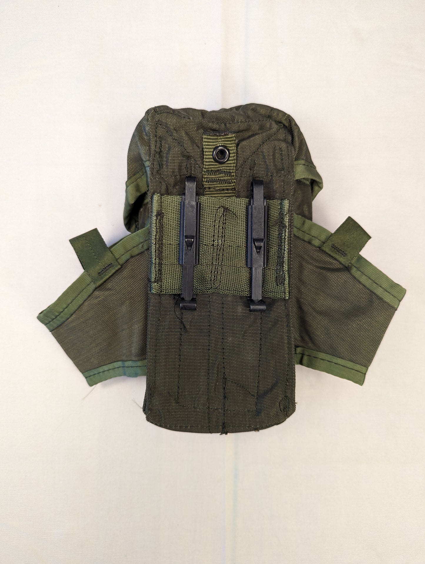 A single U.S. Military Surplus Small Arms Ammunition Pouch in olive green, laid flat and splayed open to display the inner webbing organization, flap closure, and black plastic fasteners.