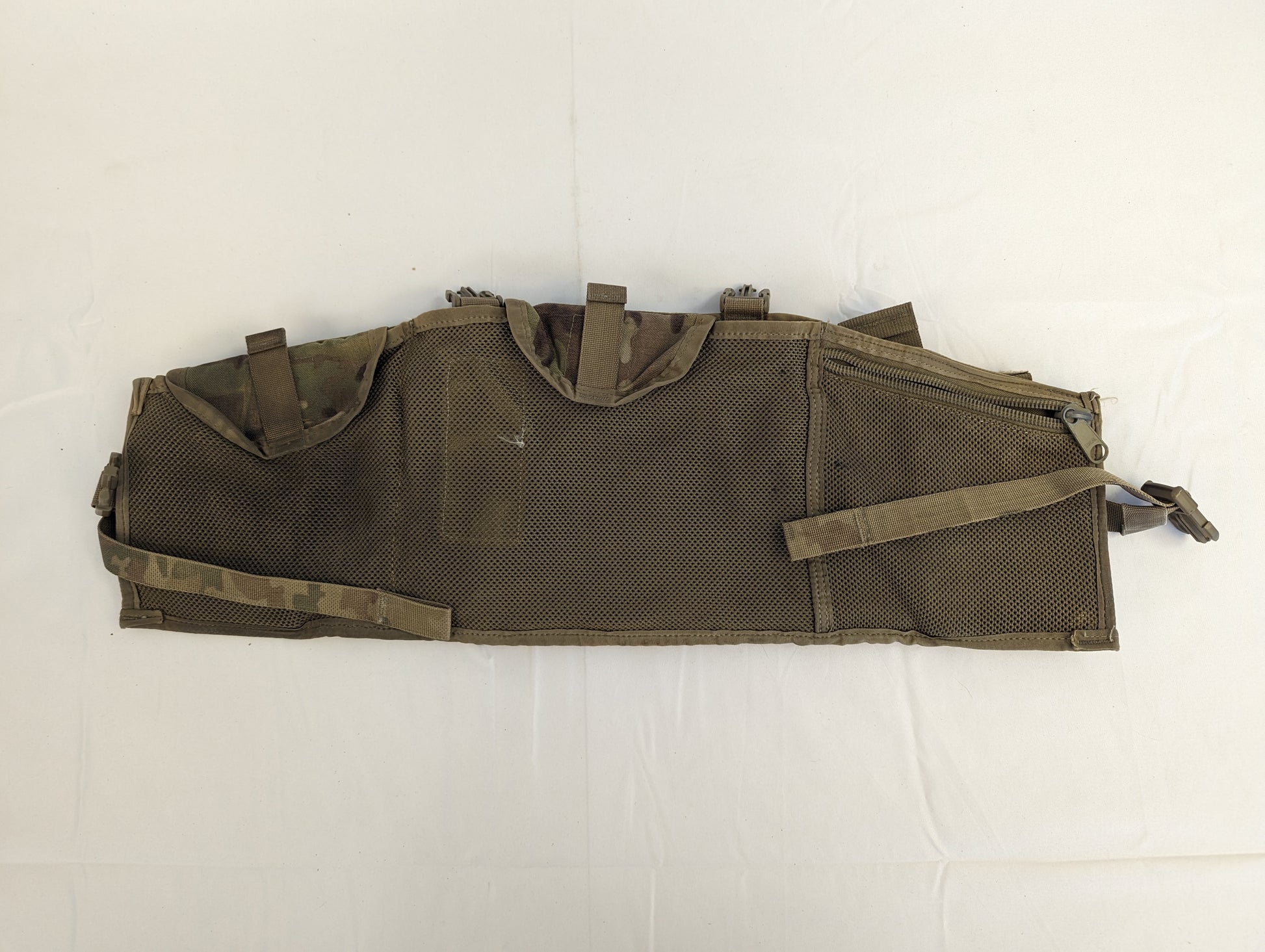 A U.S. Military Surplus Tactical Assault Panel (TAP) or Chest Rig in solid olive drab, laid flat, showcasing the full MOLLE webbing grid and the numerous strap and buckle attachment points.