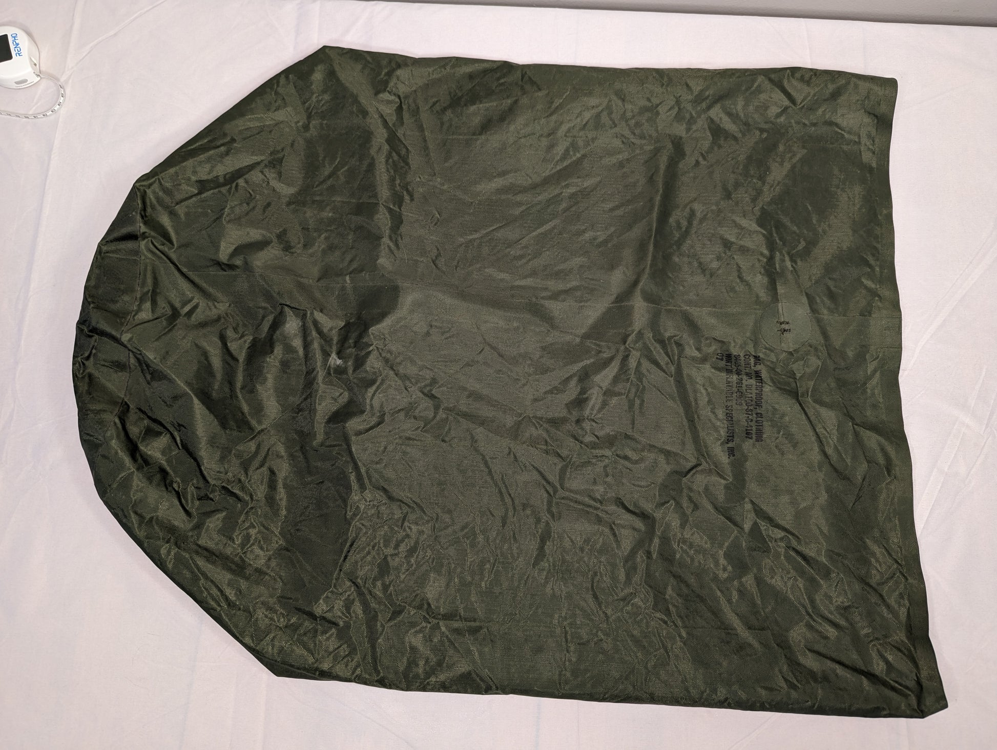 A single U.S. Military Waterproof Clothing Bag in olive green, laid flat and fully unfolded, displaying its large, rounded shape and crinkled, durable nylon fabric.
