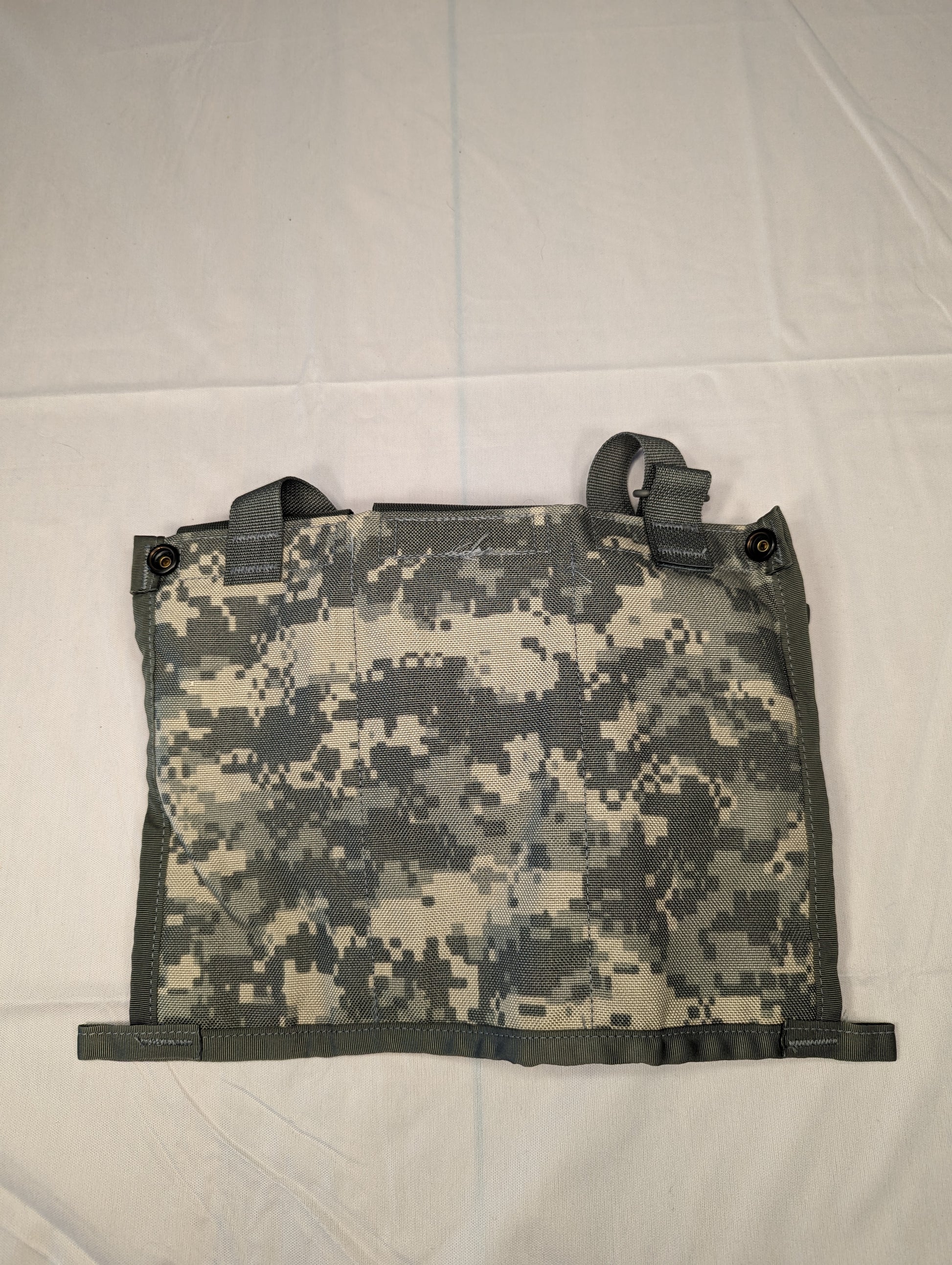 A close-up view of the body panel of a U.S. Military Surplus ACU Bandoleer, laid flat, showcasing the ACU digital camouflage pattern and the black attachment webbing.